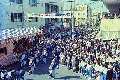 05_いわきおどり発表会・平レンガ通り：いわきおどり発表会・平レンガ通り(昭和56年10月、いわき市撮影)：平民踊愛好会を先頭に踊りの列がスタート！見物客が近隣ビルのテラスや階段にまであふれています